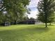 Charming single-story home with well-maintained yard and a quaint shed, perfect for outdoor enjoyment at 7897 Moore Rd, Indianapolis, IN 46278