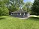 Charming home exterior with lush green lawn, offering a serene and picturesque outdoor setting for relaxation at 7897 Moore Rd, Indianapolis, IN 46278