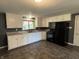 Kitchen area with appliances and white cabinets at 7897 Moore Rd, Indianapolis, IN 46278