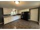 Full kitchen with white cabinets and black appliances at 7897 Moore Rd, Indianapolis, IN 46278