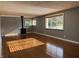 Bright living room with wood-look floors, neutral paint, and a wood-burning stove at 7897 Moore Rd, Indianapolis, IN 46278