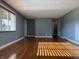 Bright living room with wood-look floors, neutral paint and a sunlit window at 7897 Moore Rd, Indianapolis, IN 46278
