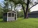 Lawn featuring outbuilding in the backyard under a large tree at 7897 Moore Rd, Indianapolis, IN 46278
