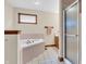 Bathroom with tile floors, tub with tile surround, shower with glass door and vanity at 802 Echo Trl, Martinsville, IN 46151