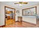 Dining area with hardwood floors, a built-in counter, and a view into the bright kitchen at 802 Echo Trl, Martinsville, IN 46151