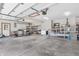 Spacious garage with concrete flooring, a white door to the exterior, and ample storage space at 802 Echo Trl, Martinsville, IN 46151