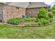 Manicured landscaping and flowerbed by brick home at 802 Echo Trl, Martinsville, IN 46151