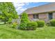 Well manicured landscaping featuring mature evergreen shrubbery and flowers at 802 Echo Trl, Martinsville, IN 46151