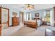 Cozy bedroom with soft carpet, wood furniture, and a tray ceiling at 802 Echo Trl, Martinsville, IN 46151