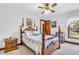 Main bedroom with a wood bed frame, carpet flooring, and natural light at 802 Echo Trl, Martinsville, IN 46151