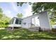 Backyard view with a sun room, deck, and a sliding glass door at 8066 Cardinal Cove E Dr, Indianapolis, IN 46256