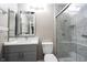 Bathroom featuring large shower with glass doors, gray cabinets and white countertops at 8066 Cardinal Cove E Dr, Indianapolis, IN 46256