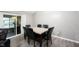 Dining room with sliding glass doors, a modern dining table, and seating for six at 8066 Cardinal Cove E Dr, Indianapolis, IN 46256