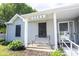 Close up of the front porch and door to the house with a bench at 8066 Cardinal Cove E Dr, Indianapolis, IN 46256