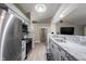 Modern kitchen features stainless steel appliances, gray cabinets, and granite countertops at 8066 Cardinal Cove E Dr, Indianapolis, IN 46256