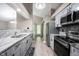 Well-lit kitchen featuring gray cabinets, stainless steel appliances, and white marbled countertops at 8066 Cardinal Cove E Dr, Indianapolis, IN 46256