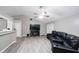 Spacious living room with gray-toned flooring, ceiling fan and large flat screen television at 8066 Cardinal Cove E Dr, Indianapolis, IN 46256