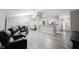 Open-concept living room with modern gray flooring, comfortable seating, and dining area at 8066 Cardinal Cove E Dr, Indianapolis, IN 46256