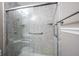 Updated walk-in shower featuring gray marble-look panels, glass door and brushed nickel grab bars at 8066 Cardinal Cove E Dr, Indianapolis, IN 46256