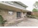 A covered back patio featuring exposed stone walls, sliding glass door, and concrete floors at 8903 Maple Hill Dr, Indianapolis, IN 46239
