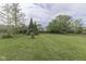 Lush backyard with expansive green lawn and mature trees creating a peaceful and private setting at 8903 Maple Hill Dr, Indianapolis, IN 46239