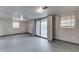 Spacious basement area with sliding doors to the outside and painted concrete walls at 8903 Maple Hill Dr, Indianapolis, IN 46239