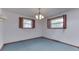 Carpeted bedroom features wood-trimmed windows, a light fixture, and baseboard heating at 8903 Maple Hill Dr, Indianapolis, IN 46239