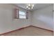 Bedroom with light fixture, hardwood floors, and wood-trimmed window with curtain at 8903 Maple Hill Dr, Indianapolis, IN 46239