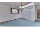 Carpeted bedroom with closet space, a light fixture, and window at 8903 Maple Hill Dr, Indianapolis, IN 46239