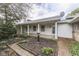 Charming covered porch with brick accents, white columns, and classic architectural details at 8903 Maple Hill Dr, Indianapolis, IN 46239