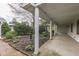 Inviting covered porch with brick landscaping, classic columns, and exterior home design at 8903 Maple Hill Dr, Indianapolis, IN 46239