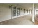 Covered porch featuring classic white columns, lantern lighting, and double entry doors at 8903 Maple Hill Dr, Indianapolis, IN 46239