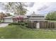 An inviting exterior view with lush landscaping and a rustic fence, enhancing the property's curb appeal at 8903 Maple Hill Dr, Indianapolis, IN 46239