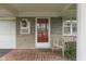 A charming front porch with a classic red door and well-maintained landscaping welcomes visitors at 8903 Maple Hill Dr, Indianapolis, IN 46239