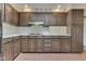 Kitchen featuring brick floors, dark wood cabinets, and a stove top at 8903 Maple Hill Dr, Indianapolis, IN 46239