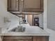 Kitchen view featuring white countertop and dark wood cabinets at 8903 Maple Hill Dr, Indianapolis, IN 46239