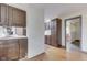 Kitchen view featuring wood floors, and dark wood cabinets at 8903 Maple Hill Dr, Indianapolis, IN 46239