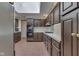Kitchen area featuring dark wood cabinets, brick floors and a skylight at 8903 Maple Hill Dr, Indianapolis, IN 46239