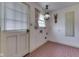 Utility room featuring brick flooring, window, door, and vintage light fixture at 8903 Maple Hill Dr, Indianapolis, IN 46239