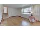 Bright living room featuring hardwood floors, a large window, and staircase to the second floor at 8903 Maple Hill Dr, Indianapolis, IN 46239
