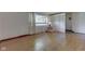 A well-lit living room featuring wood floors, large window and decorative wall paneling at 8903 Maple Hill Dr, Indianapolis, IN 46239