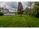 A large, well-maintained backyard features a detached garage with an asphalt driveway, and ample space for recreation at 8944 W 21St St, Indianapolis, IN 46234