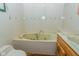 Bathroom featuring a jetted tub with faux marble and coordinated vanity at 8944 W 21St St, Indianapolis, IN 46234