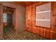 Bedroom featuring wood-paneled walls, linoleum flooring, and built-in shelving at 8944 W 21St St, Indianapolis, IN 46234