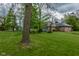 Charming brick home with well-maintained lawn, mature trees and a detached garage, offering serene countryside living at 8944 W 21St St, Indianapolis, IN 46234