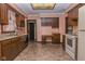 A traditional kitchen featuring wood cabinetry, linoleum flooring, and a dedicated desk area at 8944 W 21St St, Indianapolis, IN 46234