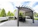 Outdoor deck featuring a pergola with shade cover and outdoor dining furniture, perfect for enjoying meals and relaxation at 8970 Buttercup Ct, Noblesville, IN 46060