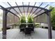Relaxing outdoor deck with a pergola, shaded seating area, and manicured evergreens for privacy at 8970 Buttercup Ct, Noblesville, IN 46060
