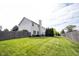 Well-maintained backyard with a green lawn, privacy fence, and mature trees offering a serene outdoor space at 8970 Buttercup Ct, Noblesville, IN 46060