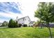 Expansive backyard with lush green grass, mature trees, and a playset, ideal for outdoor activities and relaxation at 8970 Buttercup Ct, Noblesville, IN 46060